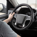 Installed view of matte black carbon-fiber-style 3-piece steering wheel cover for Chevy Silverado 1500 2014-2018 & Silverado 2500/2500HD/3500/3500HD 2015-2019 with driver holding the wheel#color=matte black