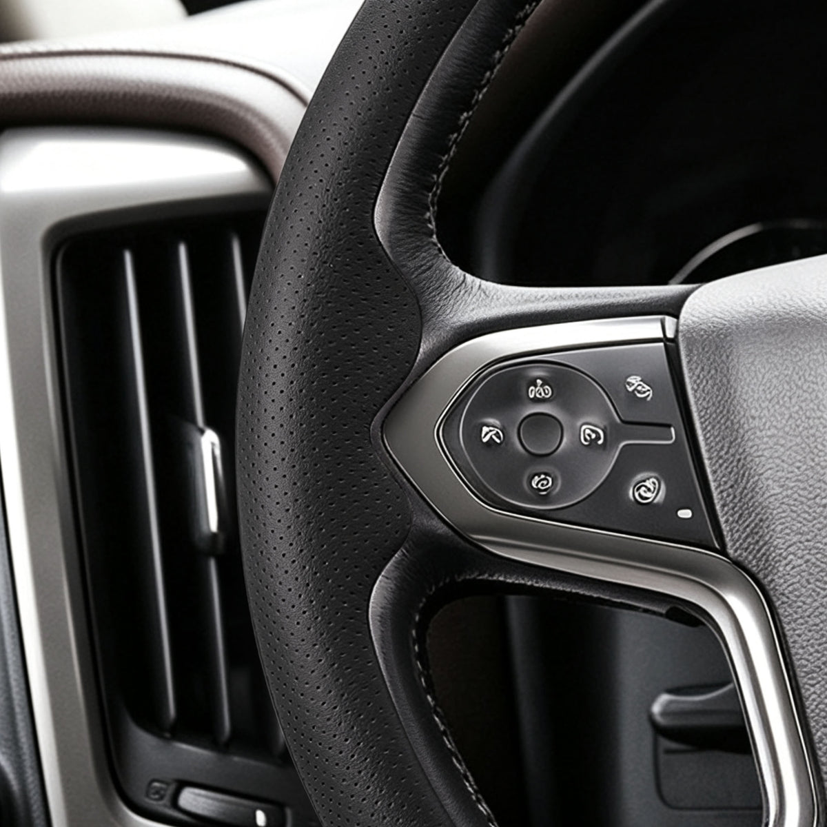 Close-up of a black perforated leather 3-piece steering wheel cover for Chevy Silverado 1500 2014-2018, showing its ergonomic 3D contours and precise custom fit