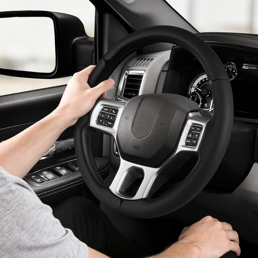 Installed view of black perforated leather 3-piece steering wheel cover for Dodge Ram 1500/2500/3500/4500/5500 2012-2018 & RAM 1500 Classic 2019-2023 with driver holding the wheel#color=black perforated leather