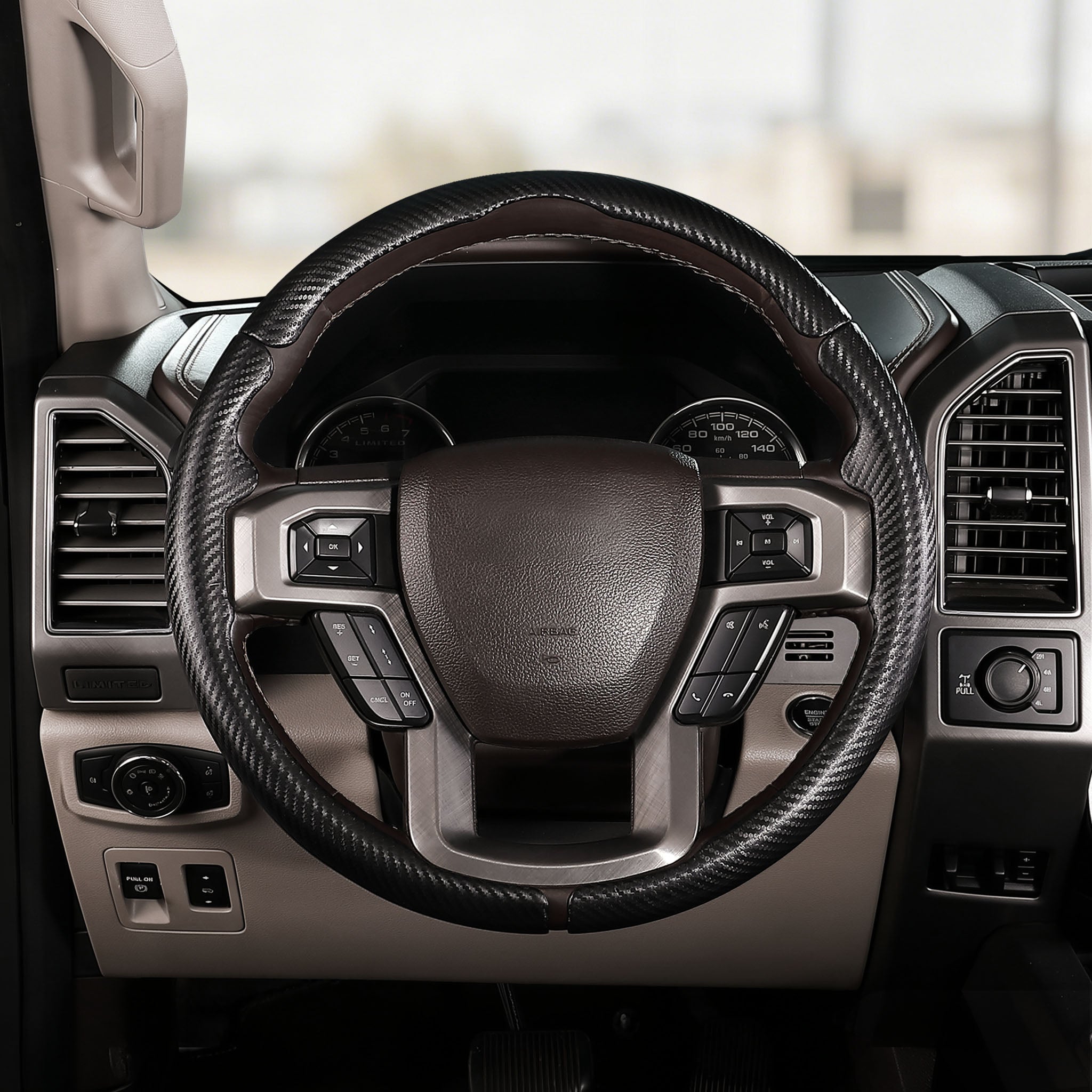 Front installed view of matte black carbon-fiber-style 3-piece steering wheel cover for Ford F-150 2015-2020