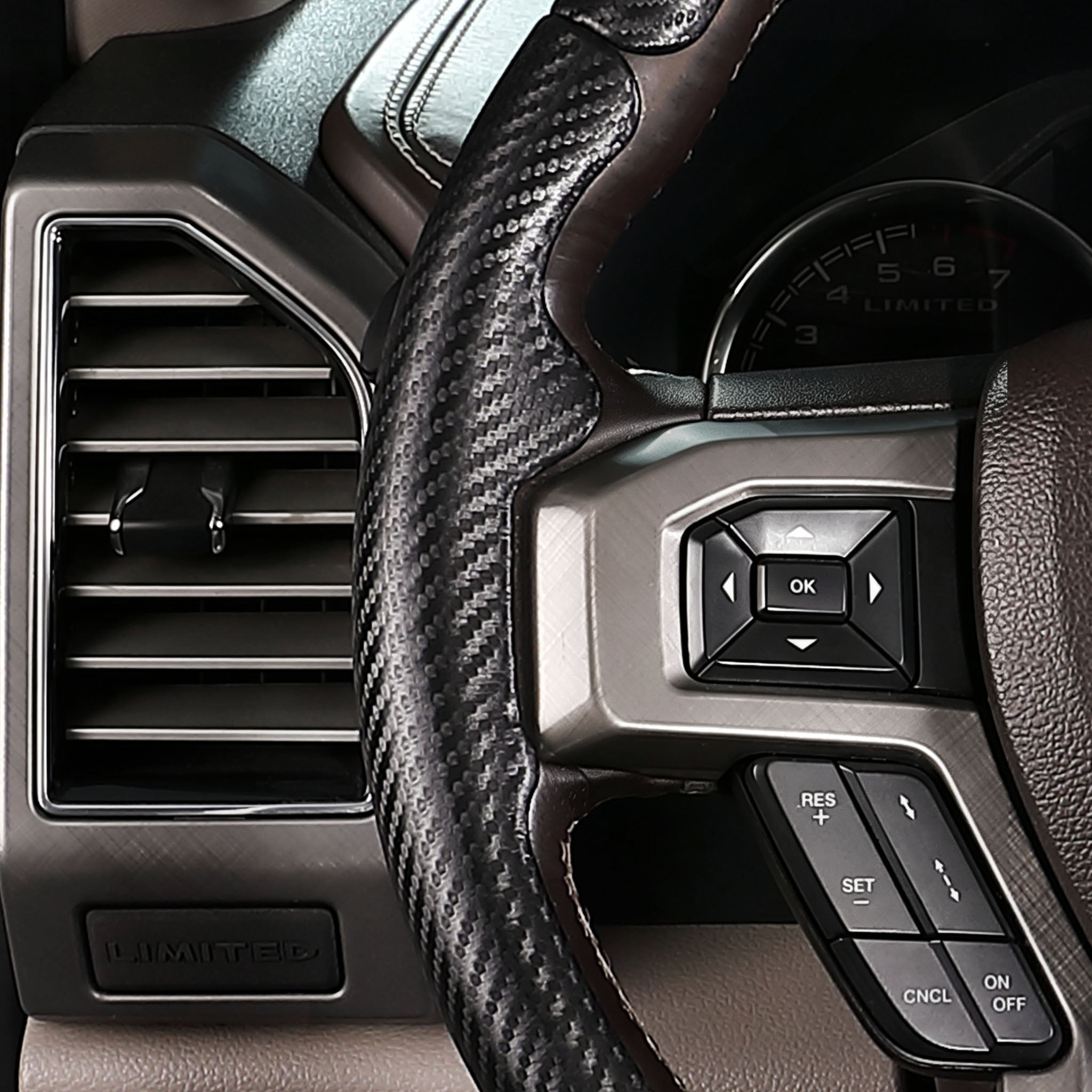 Close-up of a matte black carbon-fiber-style 3-piece steering wheel cover for Ford F-150 2015-2020, showing its ergonomic 3D contours and precise custom fit