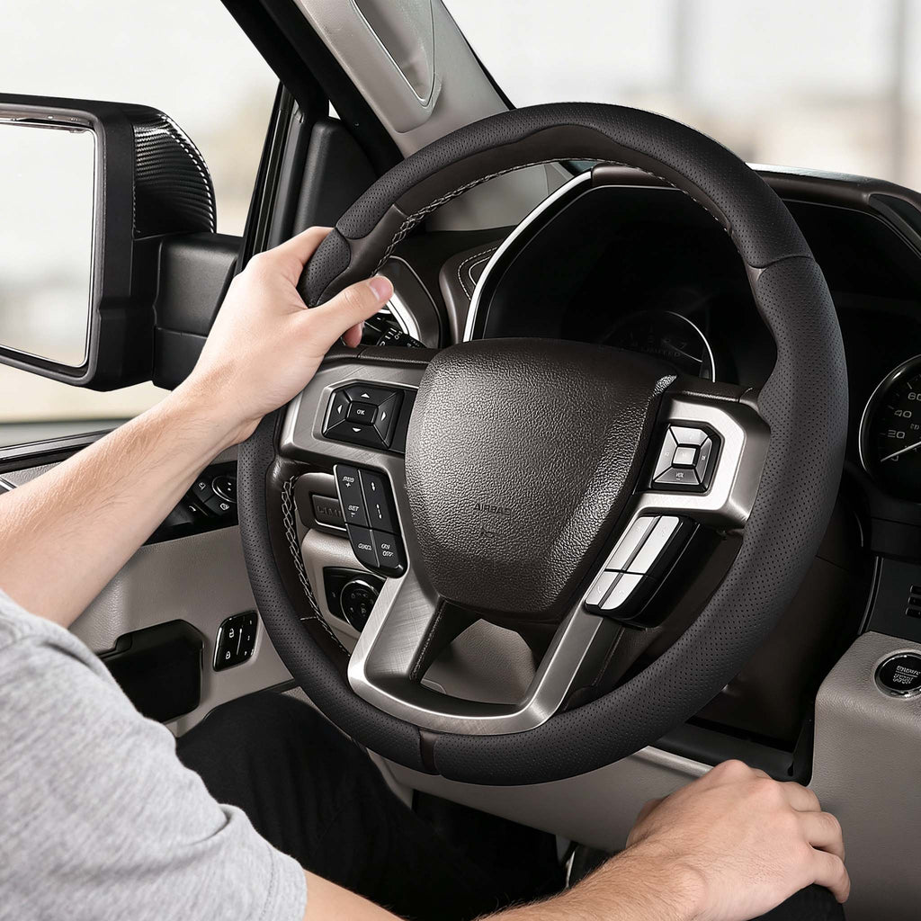 Installed view of black perforated leather 3-piece steering wheel cover for Ford F-150 2015-2020 & F-250/F-350/F-450/F-550 2017-2021 with driver holding the wheel#color=black perforated leather