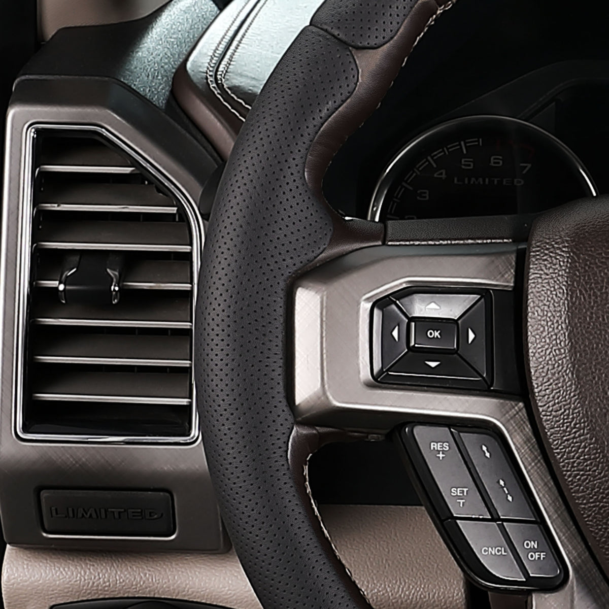 Close-up of a black perforated leather 3-piece steering wheel cover for Ford F-150 2015-2020, showing its ergonomic 3D contours and precise custom fit