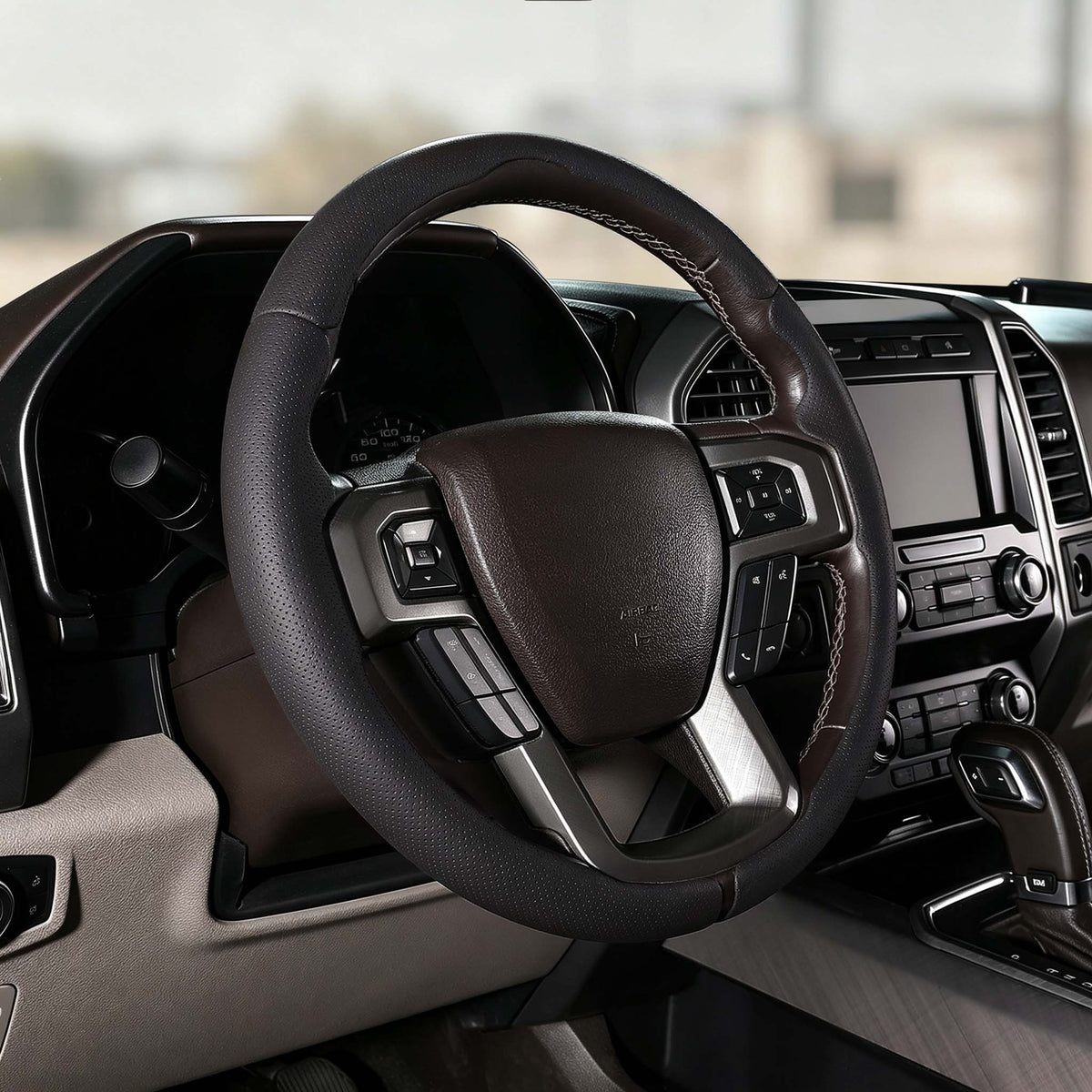 Angled installed view of black perforated leather 3-piece steering wheel cover for Ford F-150 2015-2020