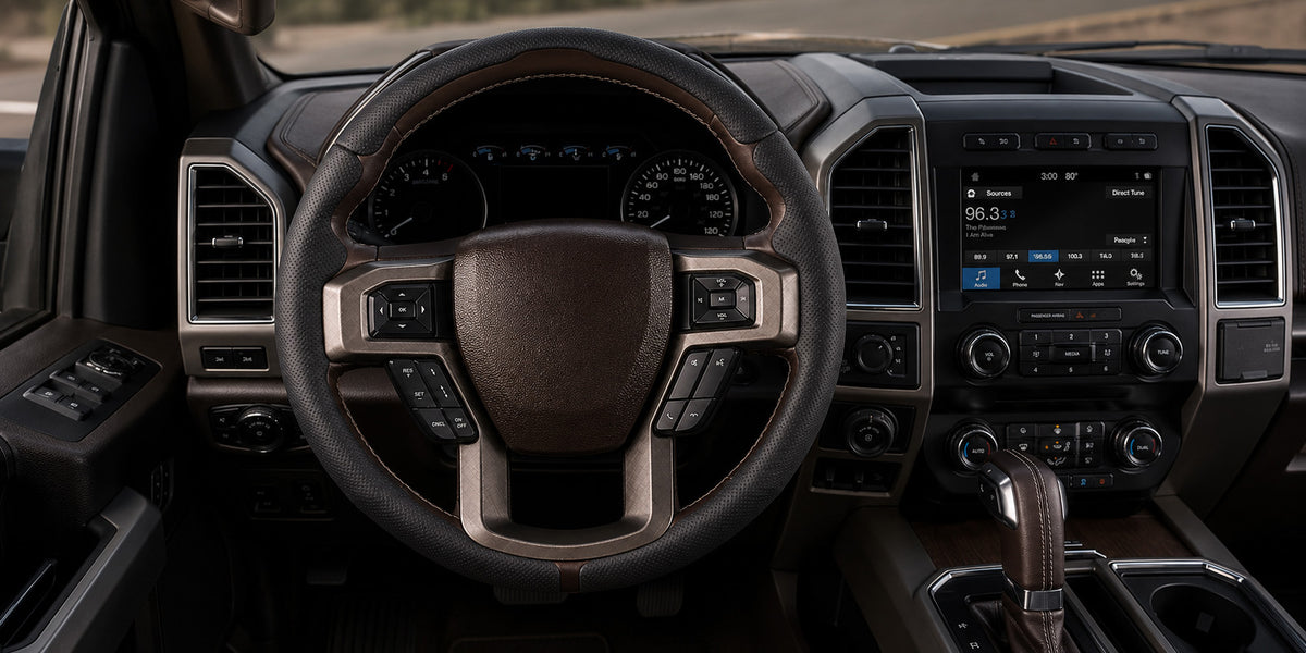 Truck steering wheel cover collection featuring a black perforated leather cover installed in a Ford F-150 interior