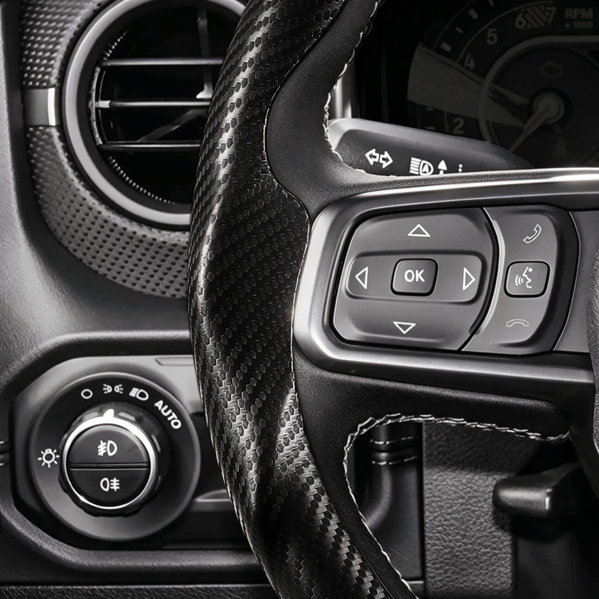 Close-up of a matte black carbon-fiber-style 3-piece steering wheel cover for Ford Jeep Wrangler 2018-2026, showing its precise custom fit