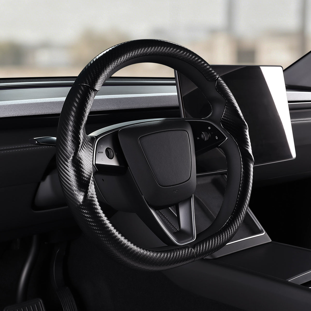 Angled installed view of matte black carbon-fiber-style 3-piece steering wheel cover for Tesla Model 3 2024-present