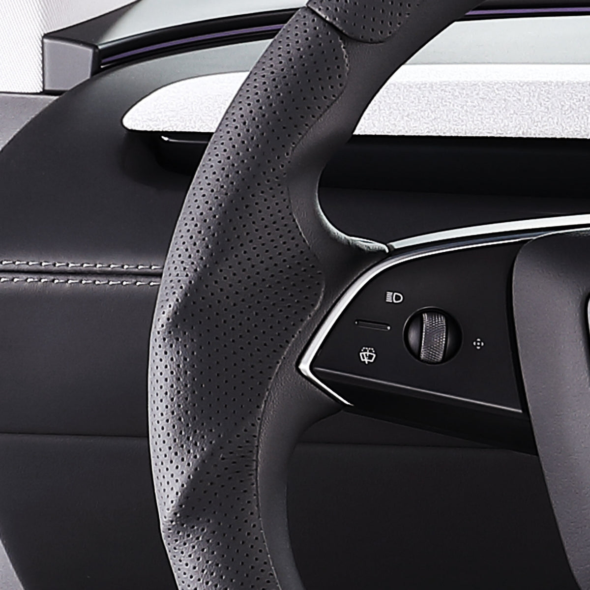 Close-up of a black perforated leather 3-piece steering wheel cover for Tesla Model 3 2024-present, showing its ergonomic 3D contours and precise custom fit