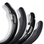 Close-up comparison of leather and carbon-fiber-style 3-piece steering wheel cover finishes for Tesla Model Y 2025-present#Model=Model Y 2025-present|color=matte black