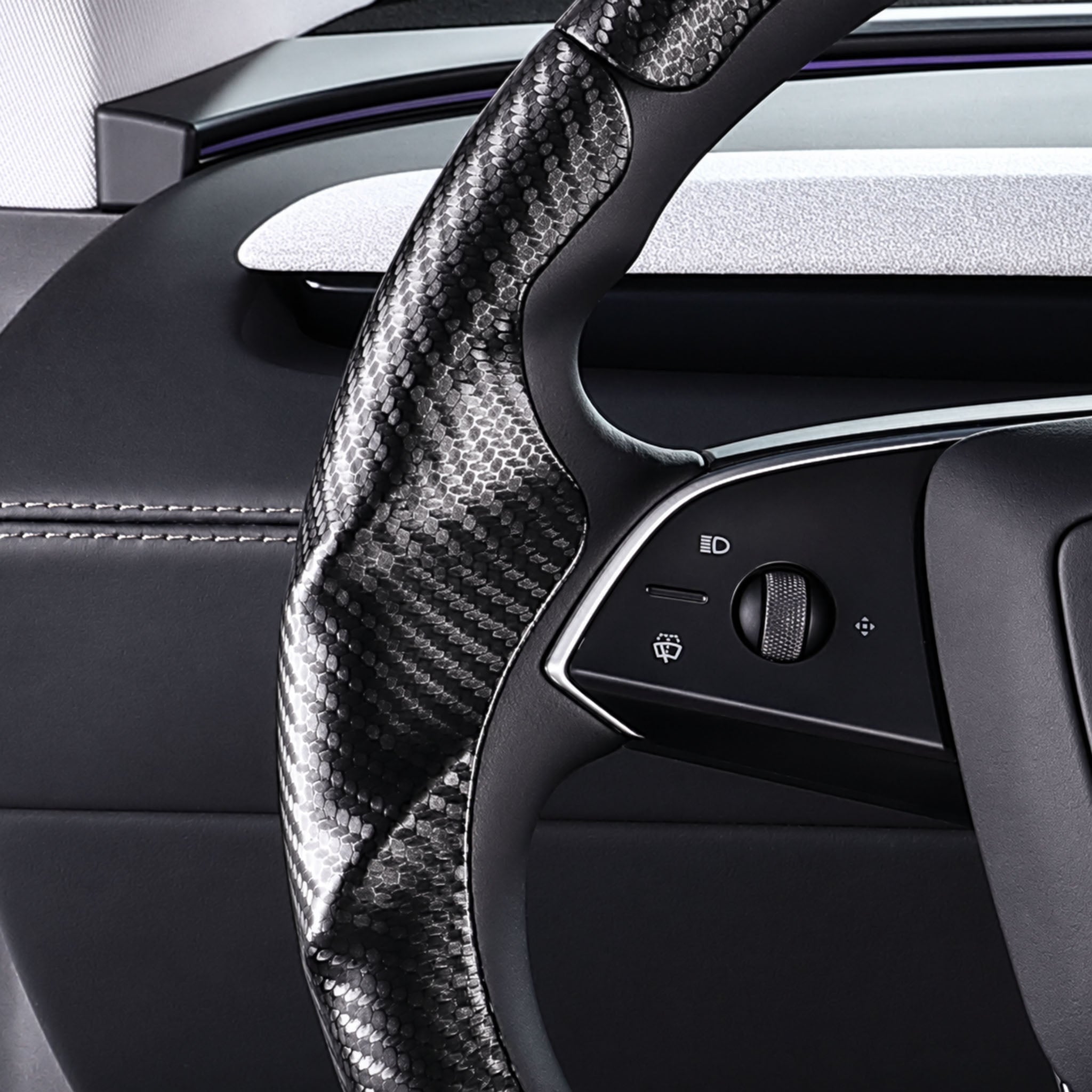 Close-up of a matte black carbon-fiber-style 3-piece steering wheel cover for Tesla Model Y 2025-present, showing its ergonomic 3D contours and precise custom fit