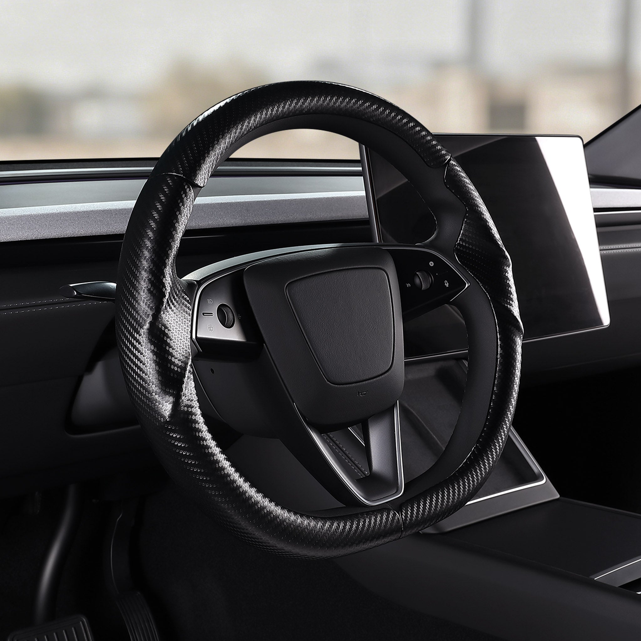 Angled installed view of matte black carbon-fiber-style 3-piece steering wheel cover for Tesla Model Y 2025-present