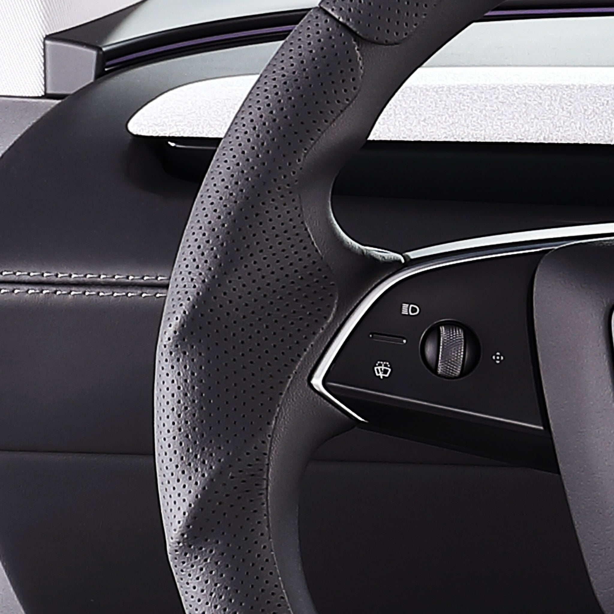 Close-up of a black perforated leather 3-piece steering wheel cover for Tesla Model Y 2025-present, showing its ergonomic 3D contours and precise custom fit