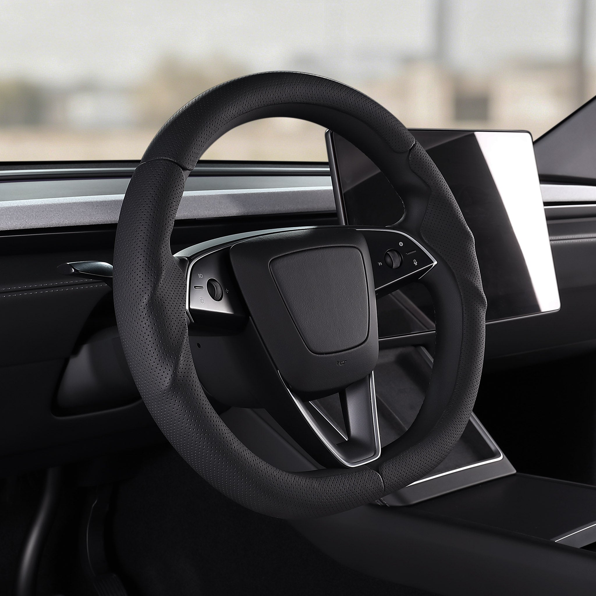Angled installed view of black perforated leather 3-piece steering wheel cover for Tesla Model Y 2025-present