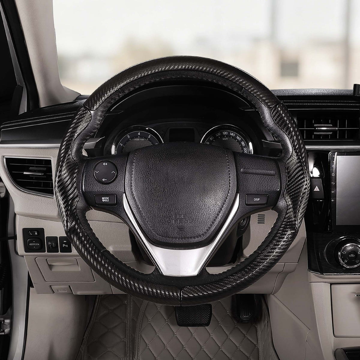 Driver's seat front view of matte black carbon-fiber-style 3-piece steering wheel cover for Toyota Camry 2015-2017