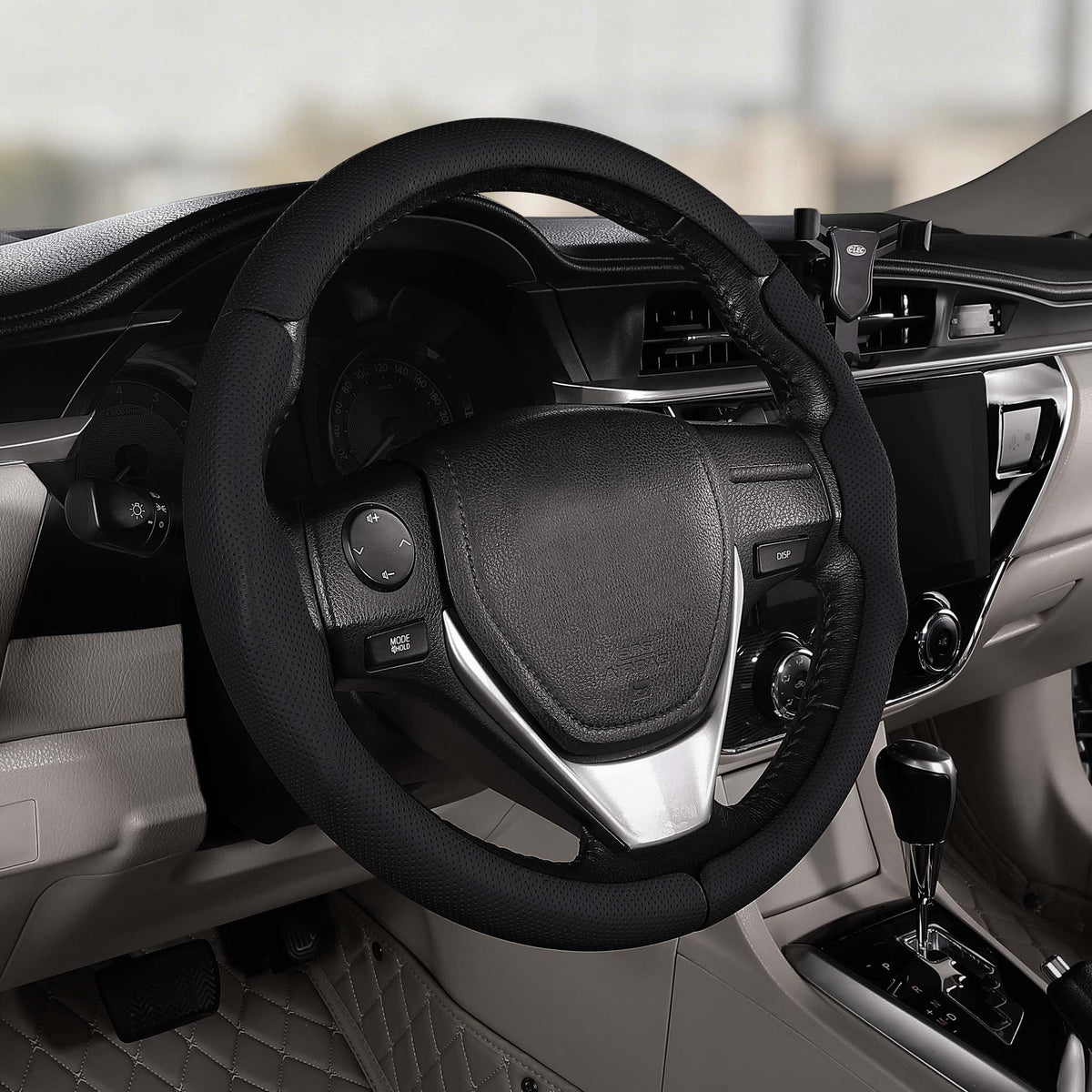 Cockpit view of black perforated leather 3-piece steering wheel cover for Toyota Camry 2015-2017