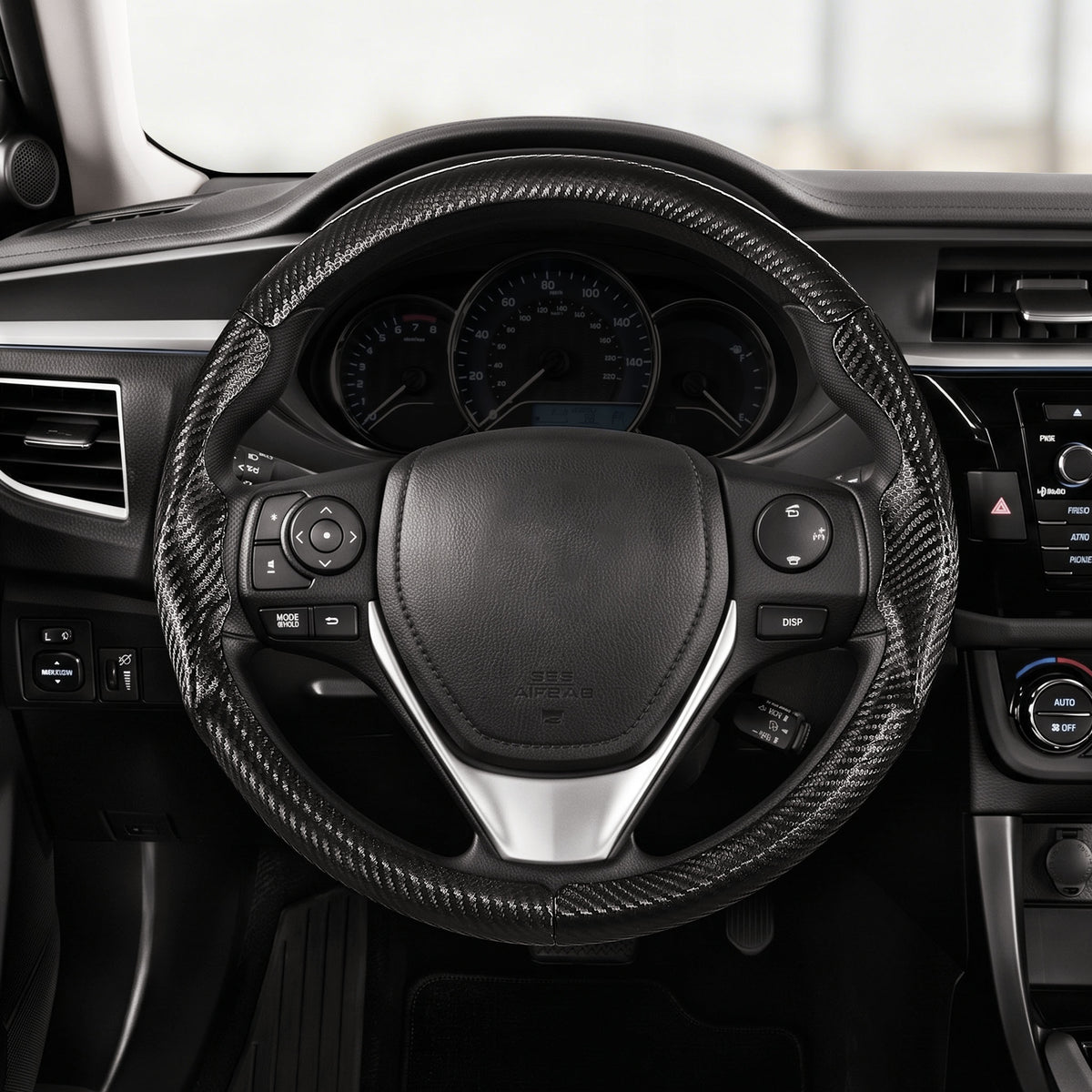 Driver's seat front view of matte black carbon-fiber-style 3-piece steering wheel cover for Toyota Corolla 2014-2019