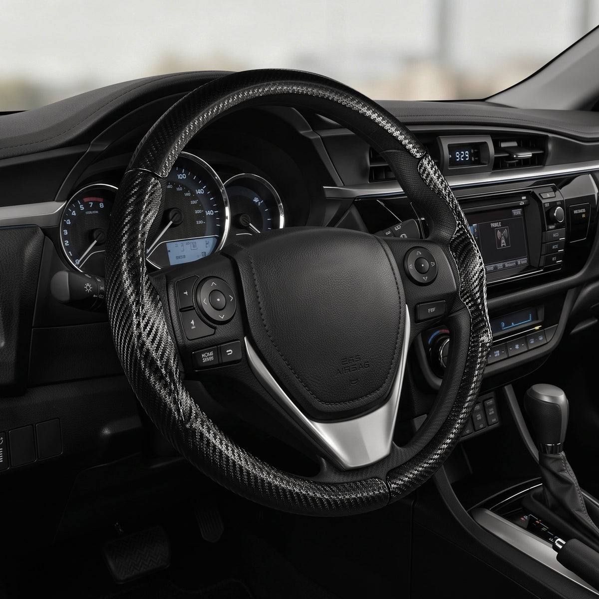 Cockpit view of matte black carbon-fiber-style 3-piece steering wheel cover for Toyota Corolla 2014-2019