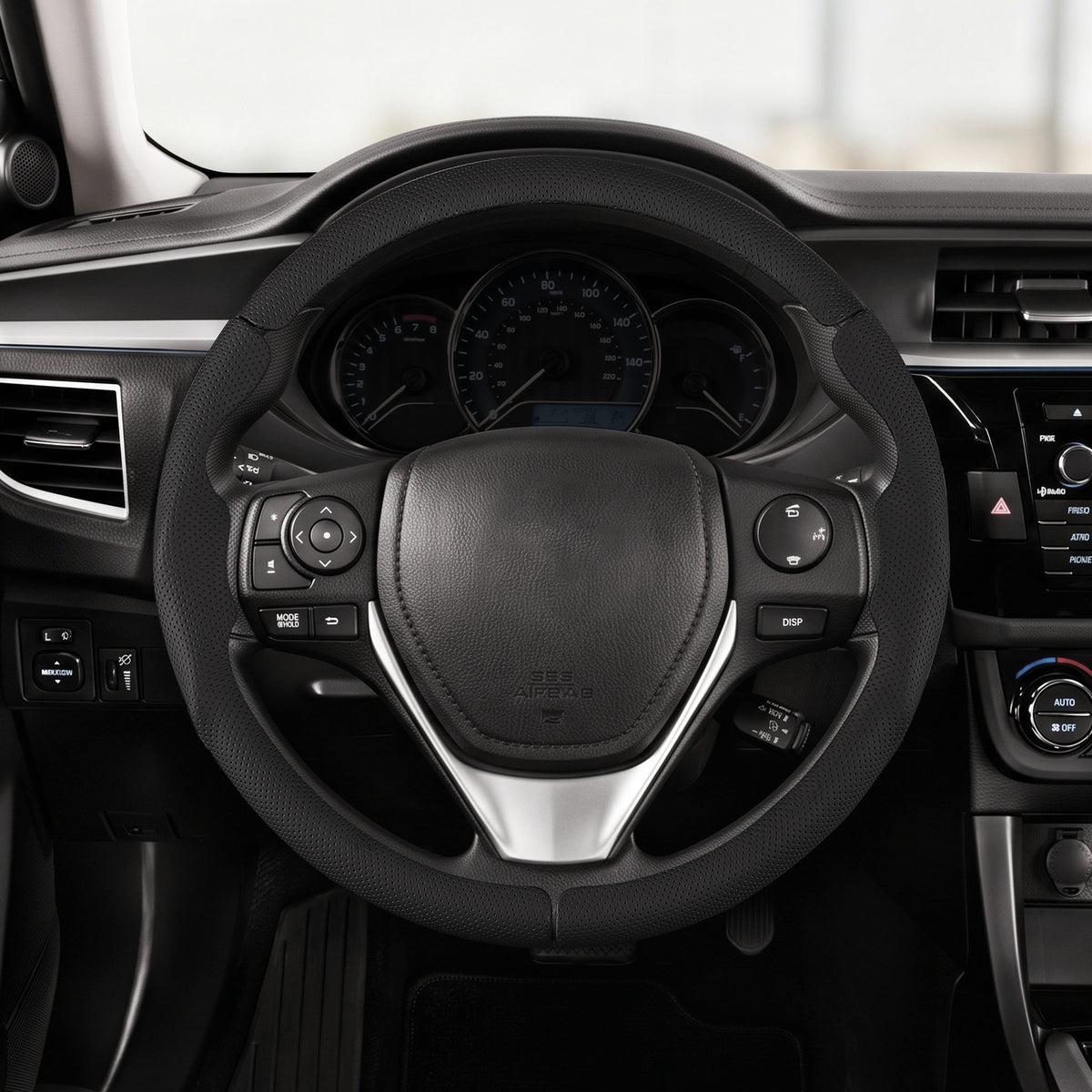 Driver's seat front view of black perforated leather 3-piece steering wheel cover for Toyota Corolla 2014-2019