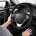 Installed view of black leather 3-piece steering wheel cover for Toyota RAV4 2013-2018 with driver holding the wheel#color=black leather