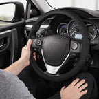 Installed view of black perforated leather 3-piece steering wheel cover for Toyota RAV4 2013-2018 with driver holding the wheel#color=black perforated leather