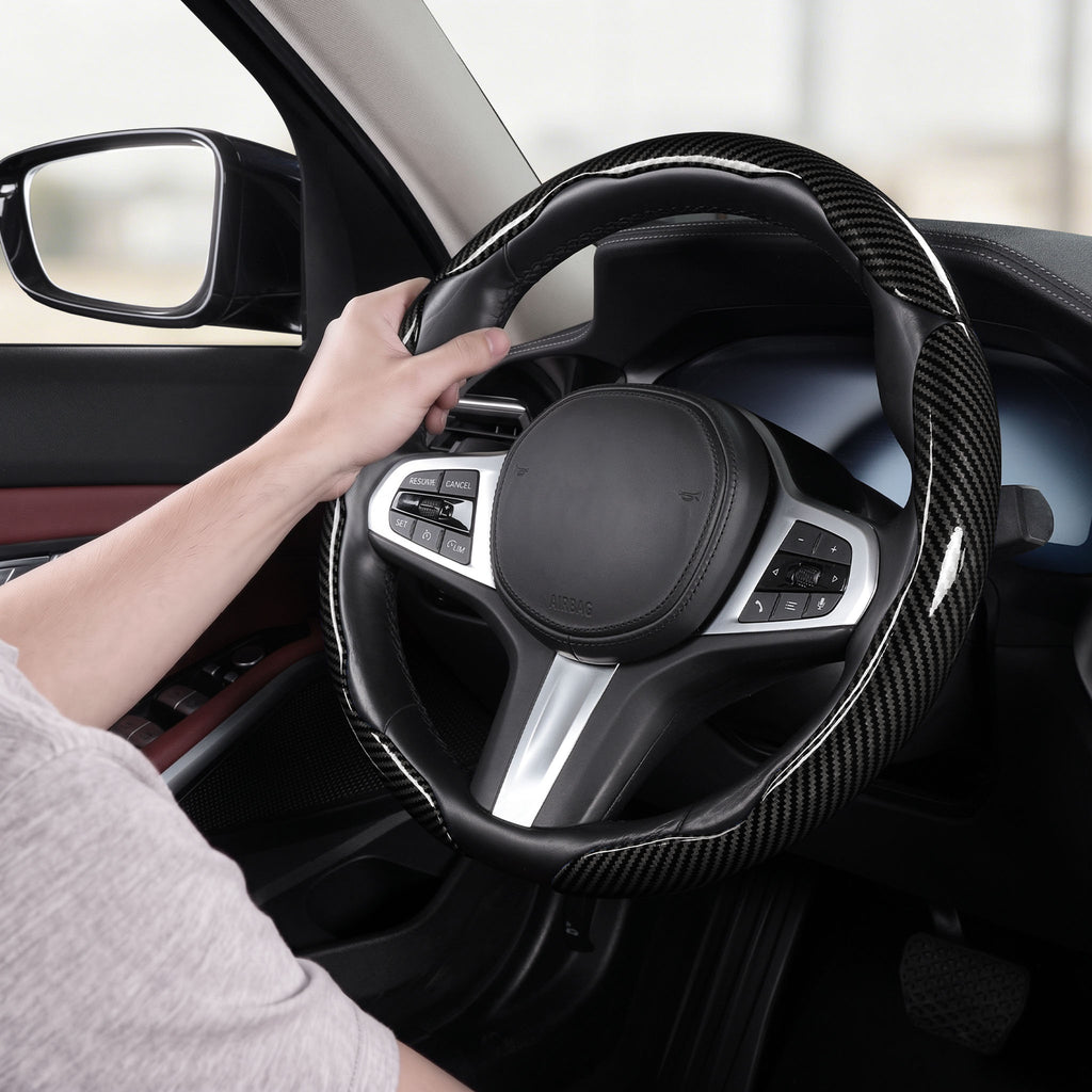Installed view of glossy black carbon-fiber-style 3-piece steering wheel cover for 14.5-15 Inch Wheels with driver holding the wheel#color=glossy black