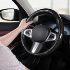 Installed view of glossy black carbon-fiber-style 3-piece steering wheel cover for 14.5-15 Inch Wheels with driver holding the wheel#color=glossy black