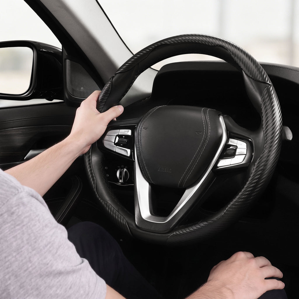 Installed view of matte black carbon-fiber-style 3-piece steering wheel cover for 14.5-15 Inch Wheels with driver holding the wheel#color=matte black
