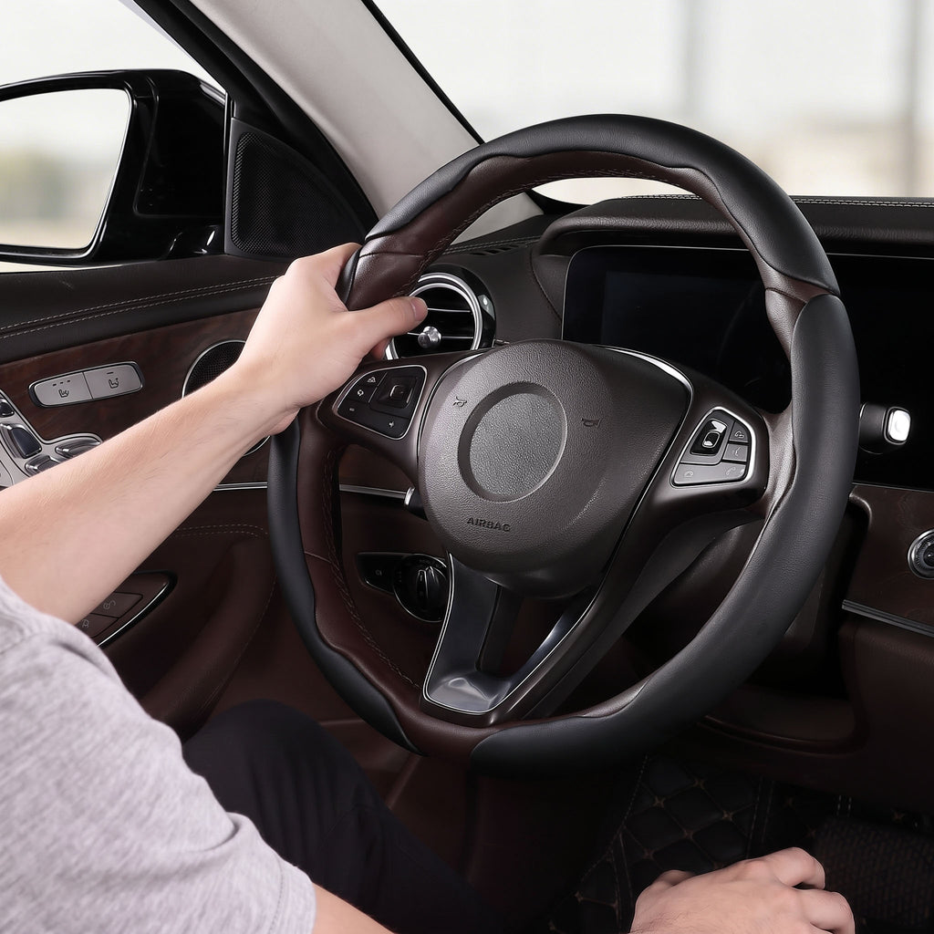 Installed view of black leather 3-piece steering wheel cover for 14.5-15 Inch Wheels with driver holding the wheel#color=black leather