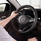 Installed view of black leather 3-piece steering wheel cover for 14.5-15 Inch Wheels with driver holding the wheel#color=black leather
