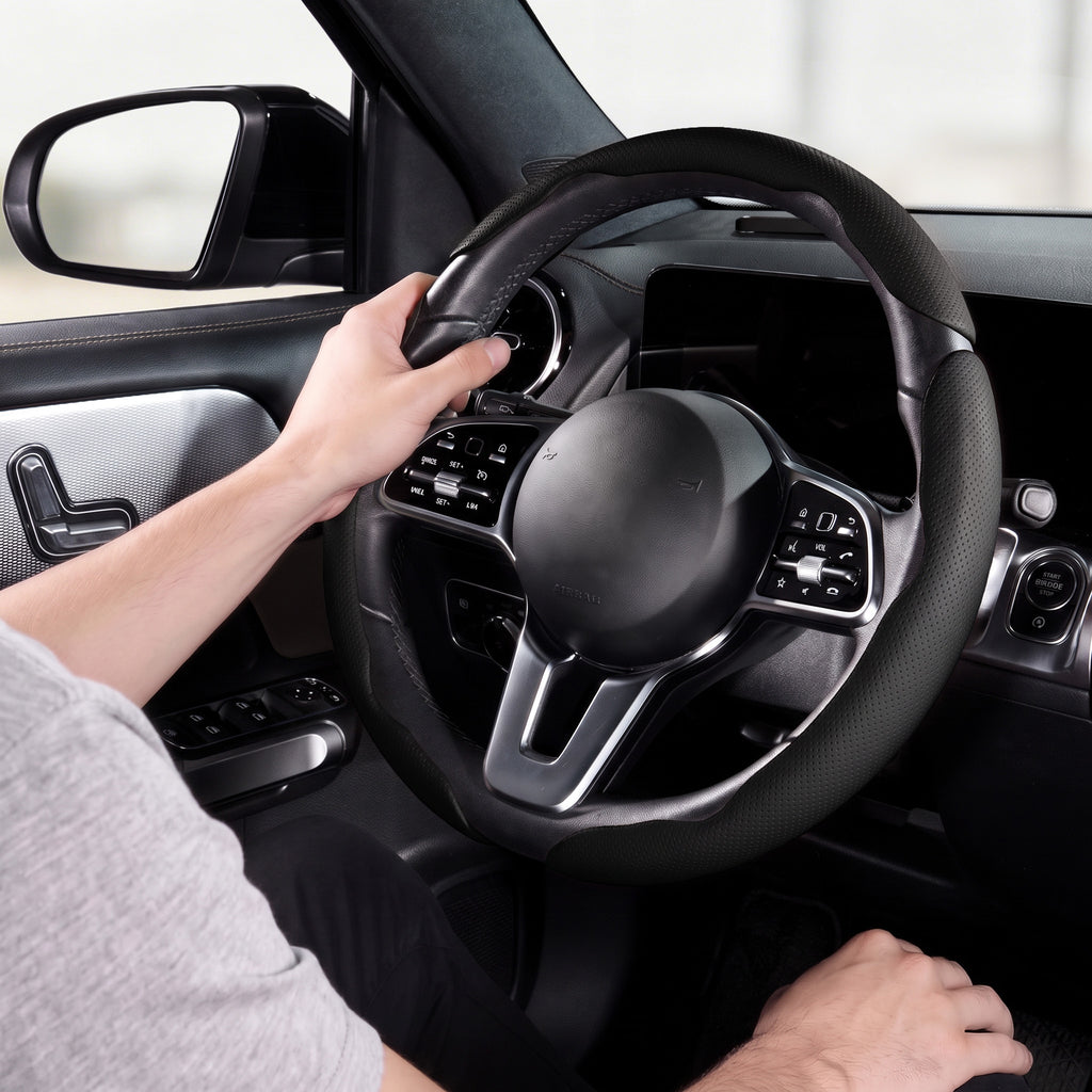 Installed view of black perforated leather 3-piece steering wheel cover for 14.5-15 Inch Wheels with driver holding the wheel#color=black perforated leather