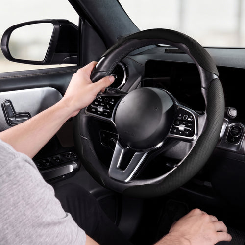 Installed view of black perforated leather 3-piece steering wheel cover for 14.5-15 Inch Wheels with driver holding the wheel#color=black perforated leather