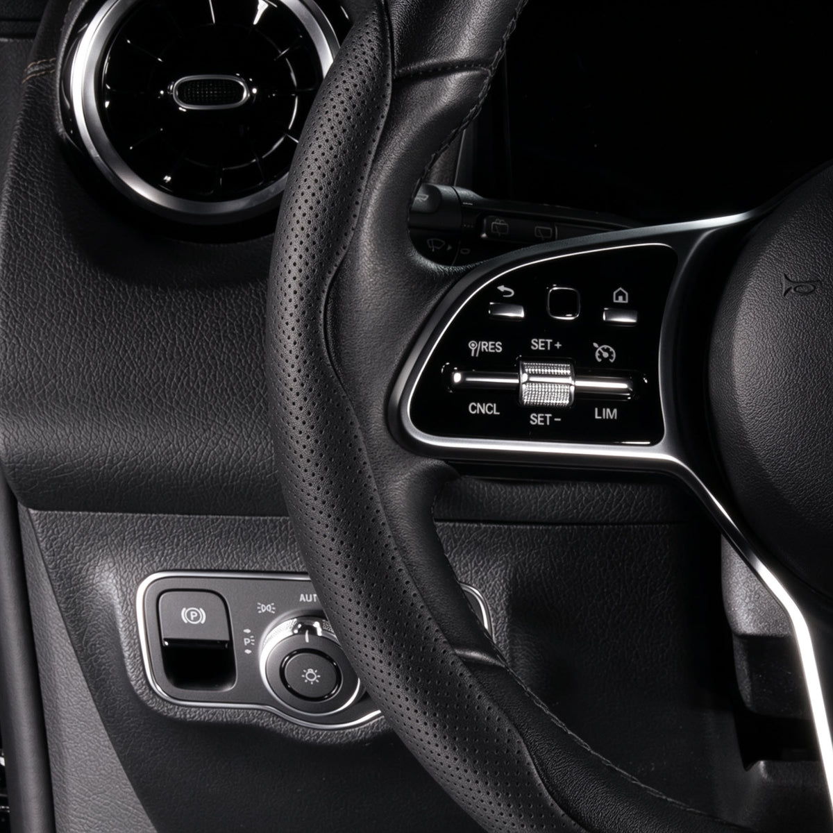 Close-up of a black perforated leather 3-piece steering wheel cover for 14.5-15 Inch Wheels