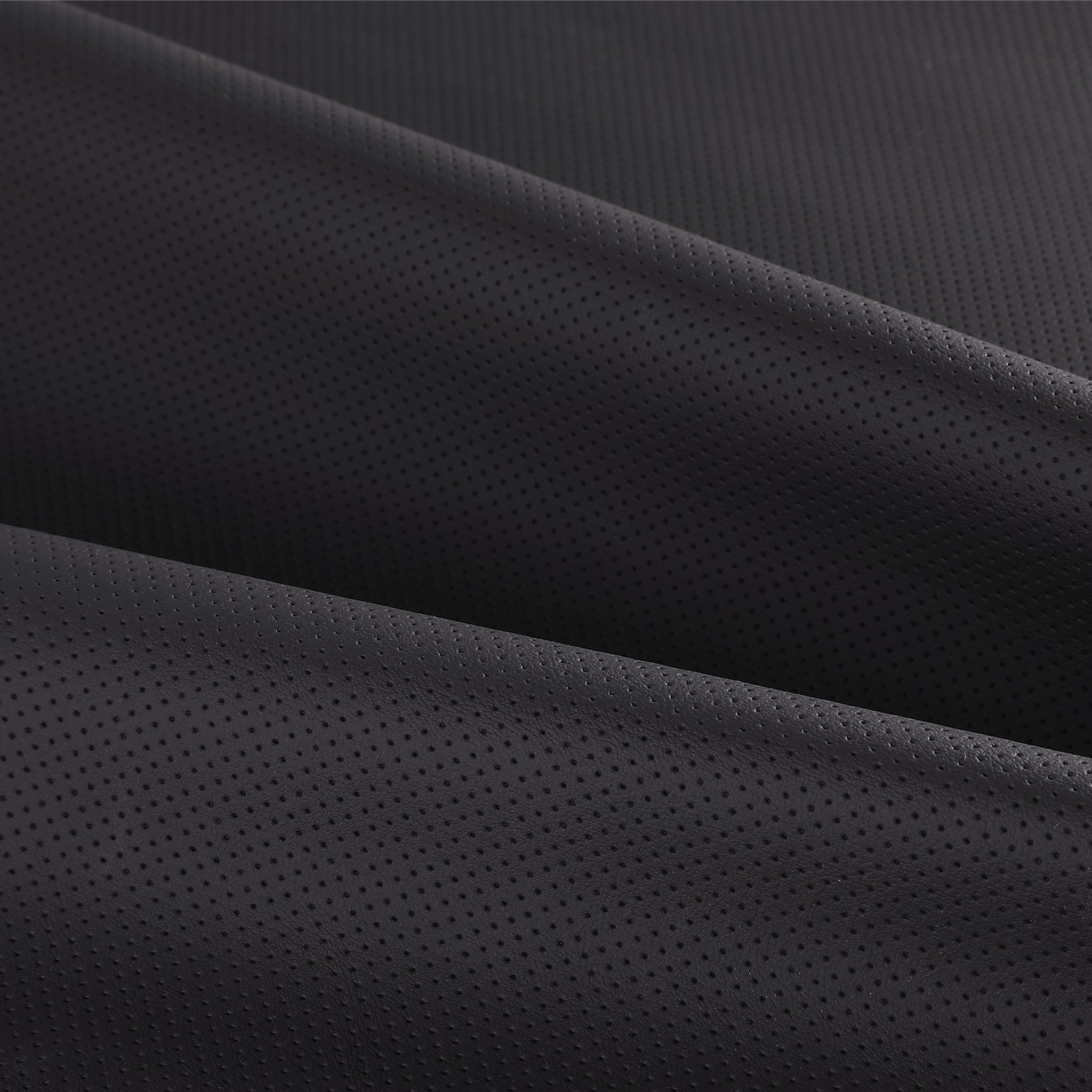 Close-up of black perforated leather material used on LOPHNIX steering wheel covers
