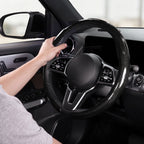 Installed view of glossy black carbon-fiber-style steering wheel cover for 14.5-15 Inch Wheels with driver holding the wheel#color=glossy black