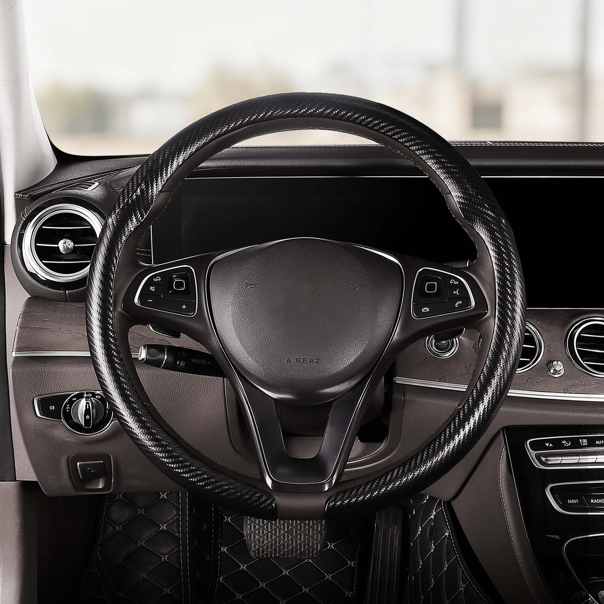 Front installed view of matte black carbon-fiber-style steering wheel cover for 14.5-15 Inch Wheels