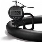 Digital thickness gauge showing the 0.09-inch ultra-slim profile of a black leather steering wheel cover#color=black leather