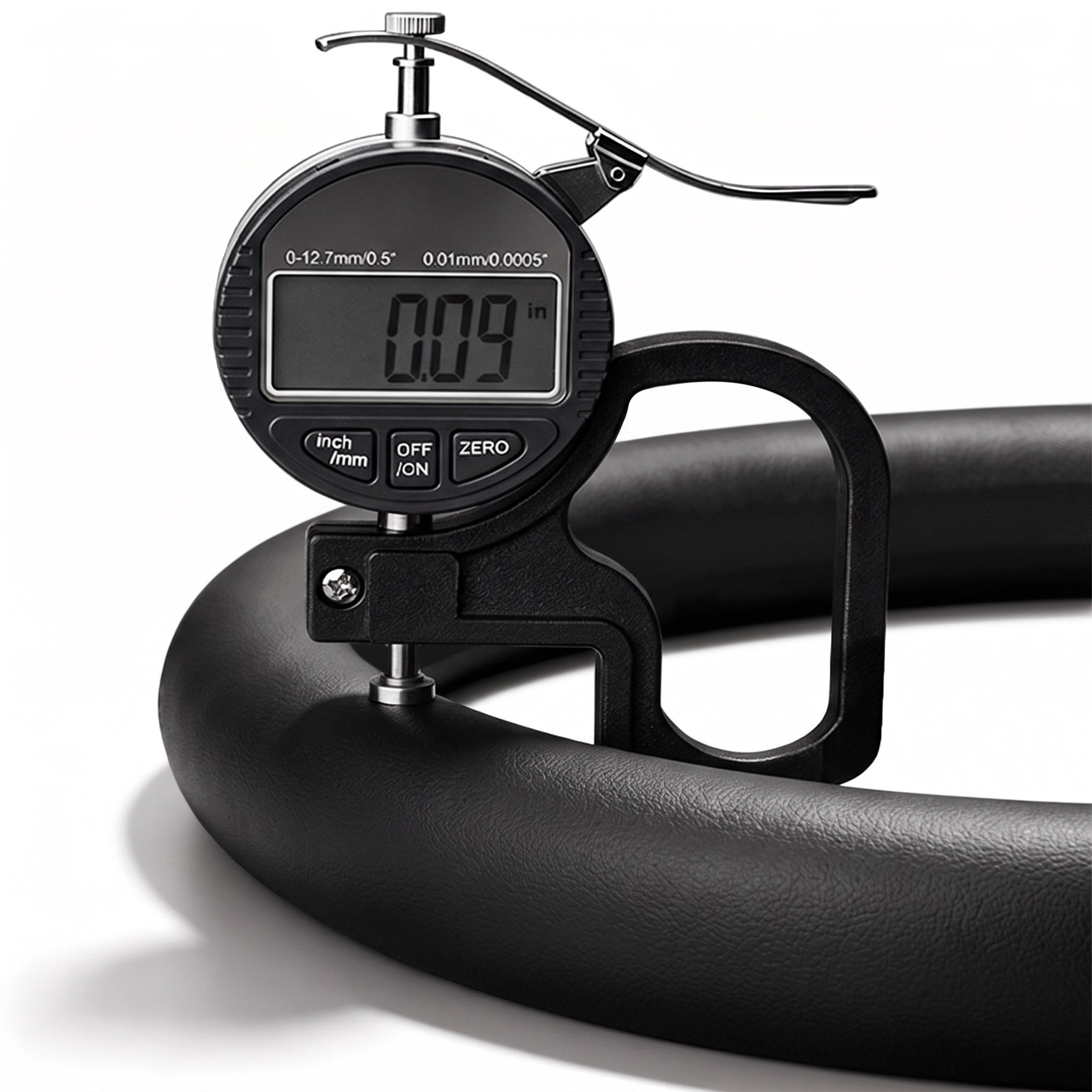 Digital thickness gauge showing the 0.09-inch ultra-slim profile of a black leather steering wheel cover#color=black leather