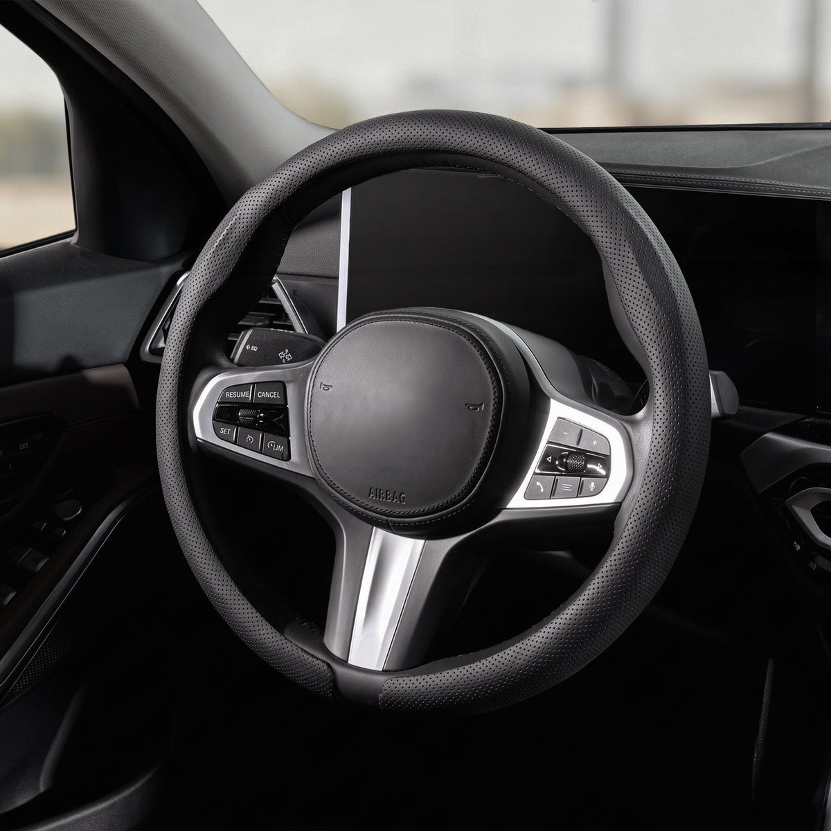 Cockpit view of black perforated leather steering wheel cover for 14.5-15 Inch Wheels