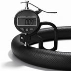 Digital thickness gauge showing the 0.09-inch ultra-slim profile of a black perforated leather steering wheel cover#color=black perforated leather